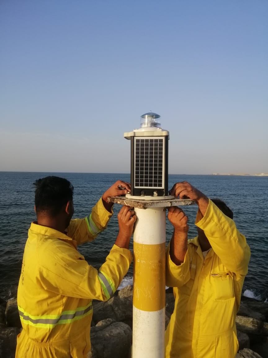 Technicians maintaining navigation buoys and lanterns